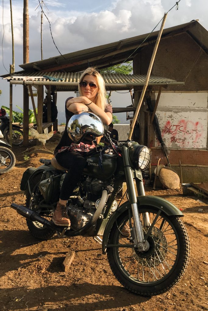 Mia astride a Royal Enfield Bullet 500 whilst riding across Indonesia recently.