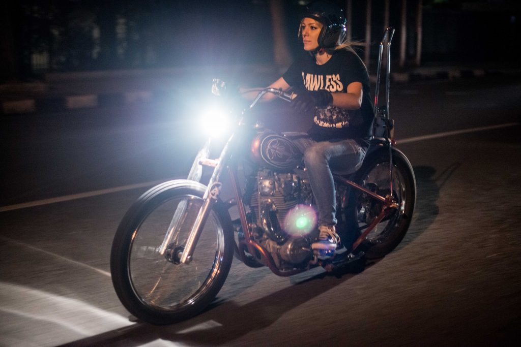 Mia enjoying a night ride with her prized 1998 H-D Roadsrer Rigid (Photo Credit: @sam.bin)